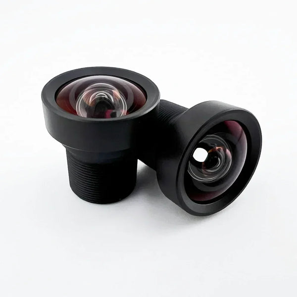 Two Commonlands CIL034 low-distortion M12 lenses on a white background, one upright showing the M12 thread below the wide front element and one resting on its side showing the front element
