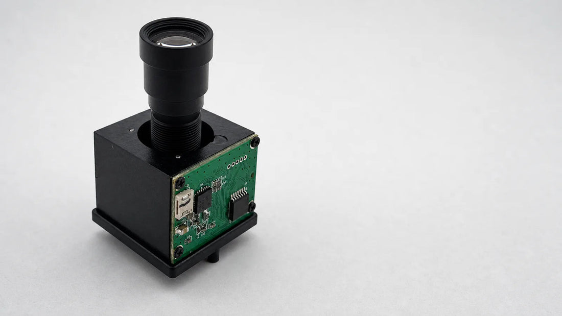 A piezoelectric autofocus actuator carrying a small M12 lens on a board-level camera module