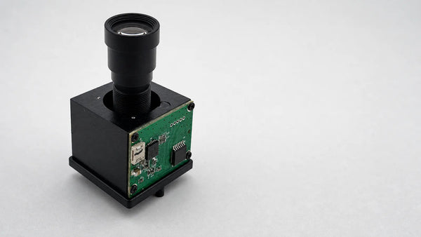 A piezoelectric autofocus actuator carrying a small M12 lens on a board-level camera module