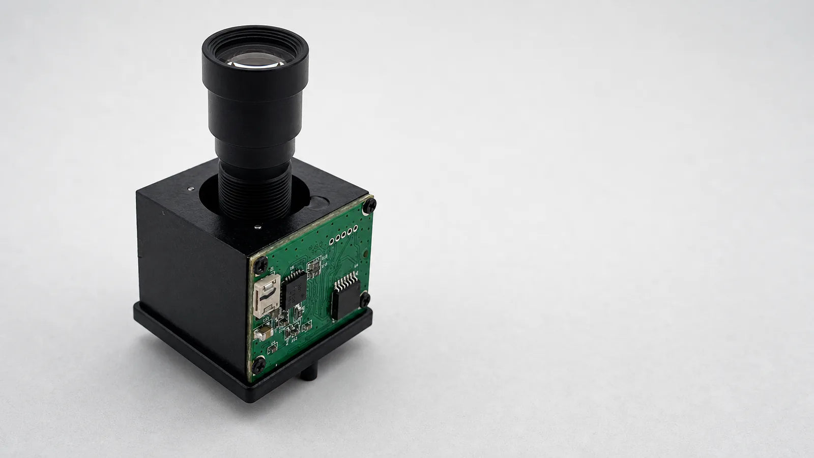 Commonlands piezoelectric M12 autofocus actuator carrying a small lens on a board-level camera module