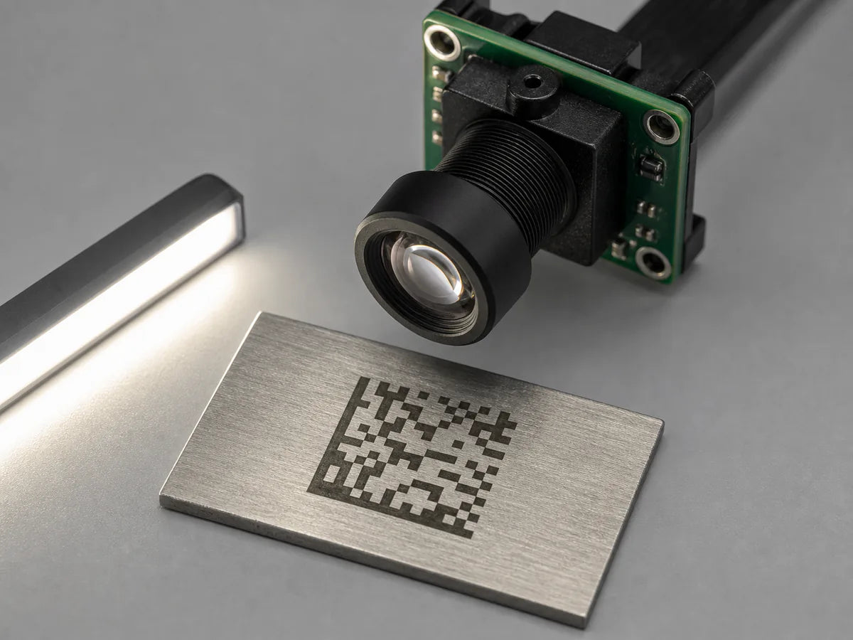 A Commonlands M12 lens images a Data Matrix code etched into a metal part