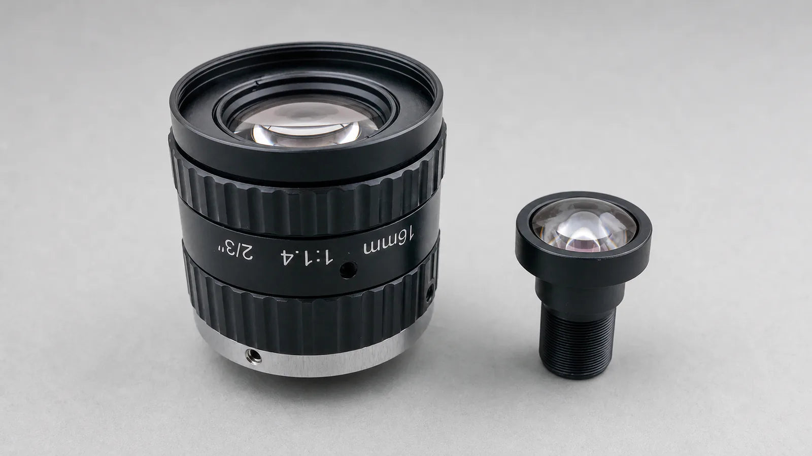 A Commonlands C-mount lens down its optical axis, iris open to the circular f-number aperture