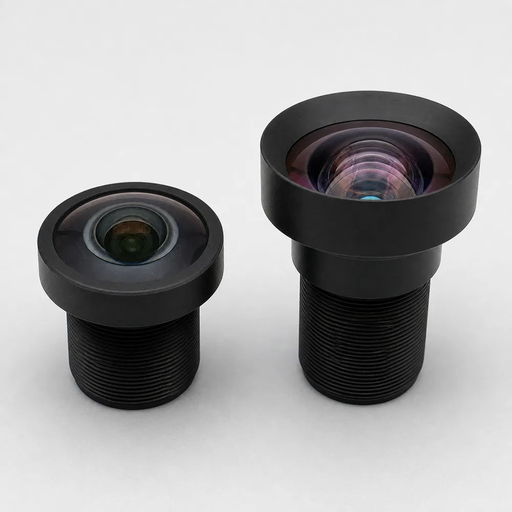 Commonlands domed fisheye M12 lens beside a flat rectilinear M12 lens on gray