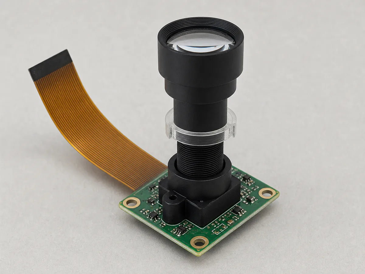 A Commonlands telephoto M12 lens with a tall barrel on a board-level camera