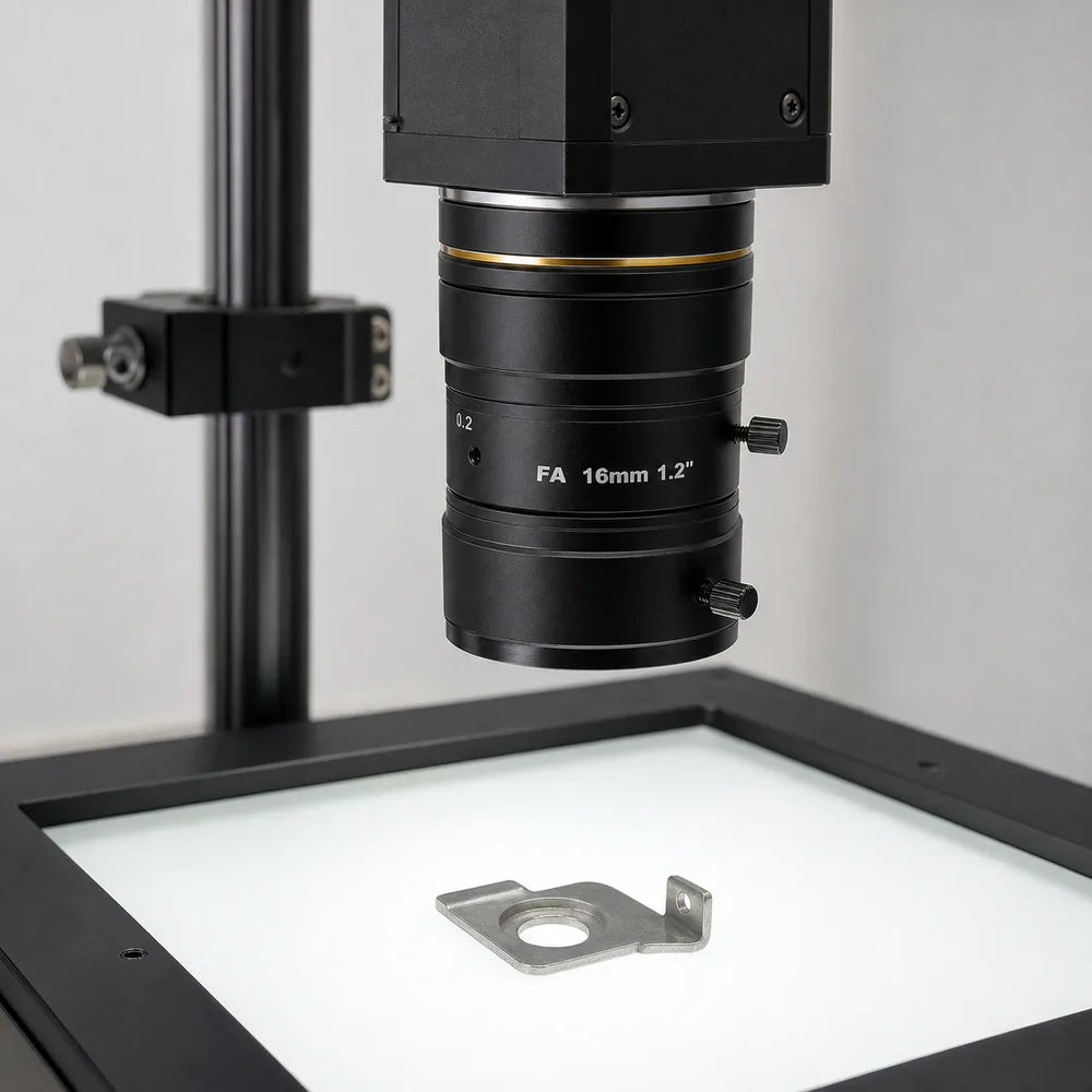 A machined part backlit from below under an inspection camera to silhouette its edges