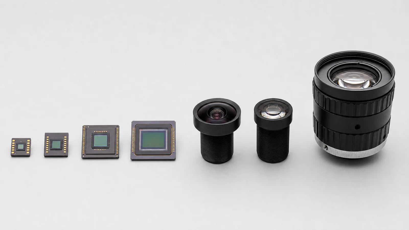 Commonlands M12 and C-mount lenses beside CMOS sensors of several formats