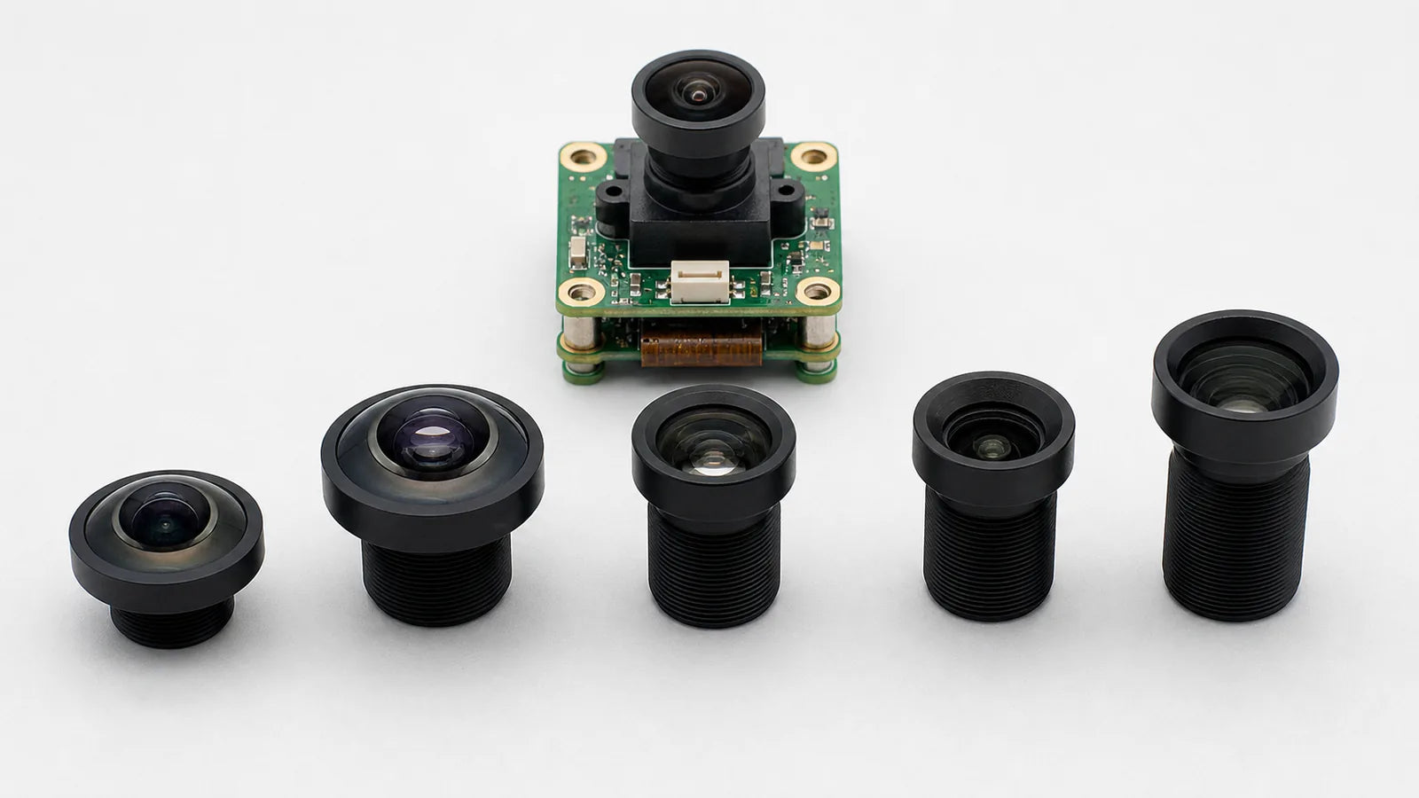 A lineup of M12 lenses across focal lengths beside a board-level camera PCB