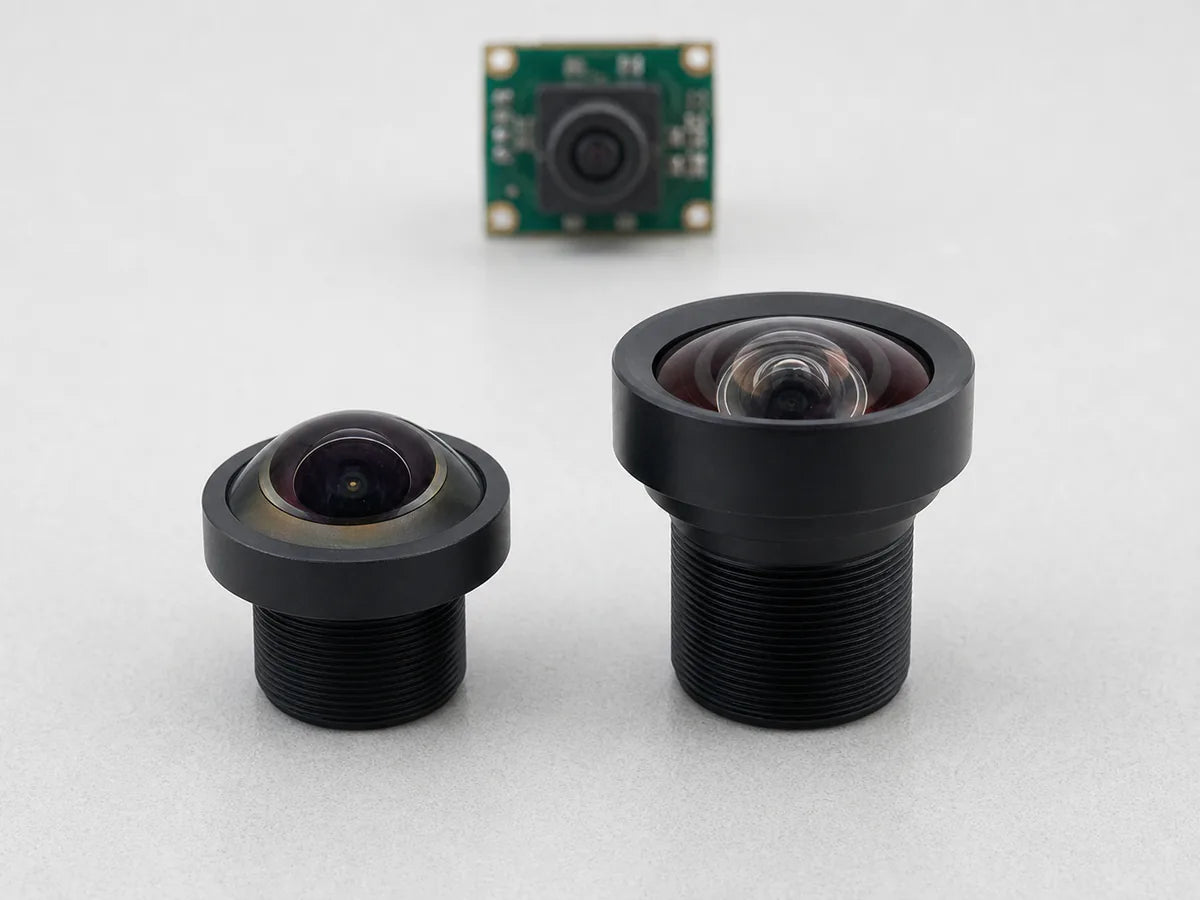 Commonlands fisheye M12 lens beside a rectilinear wide-angle lens, comparing front-element profiles