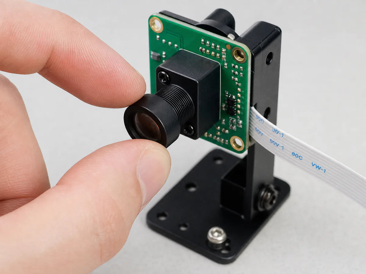 A Commonlands M12 lens threaded onto a Raspberry Pi HQ-style board camera on a robotics rig